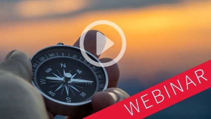 a play button and the word "webinar" superimposed over fingers holding a compass against a sunset