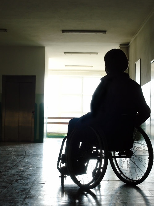 silhouetted individual in a wheelchair