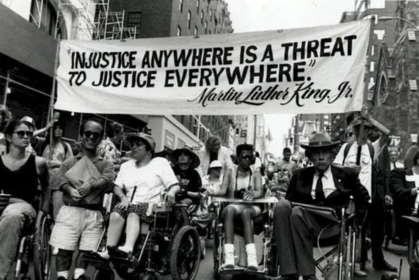 A protest scene of people in wheelchairs